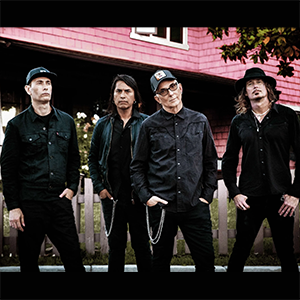 Everclear band members strut across a vintage urban crosswalk in striking black-and-white promo art for their January 18, 2026 Baton Rouge show.