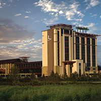 Exterior view of L’Auberge Casino and Hotel Baton Rouge featuring the modern resort tower and surrounding grounds highlighting a premier casino hotel dining and entertainment destination in Baton Rouge Louisiana.